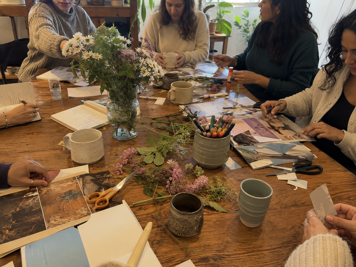 People arranging flowers, journaling, and making collages over coffee